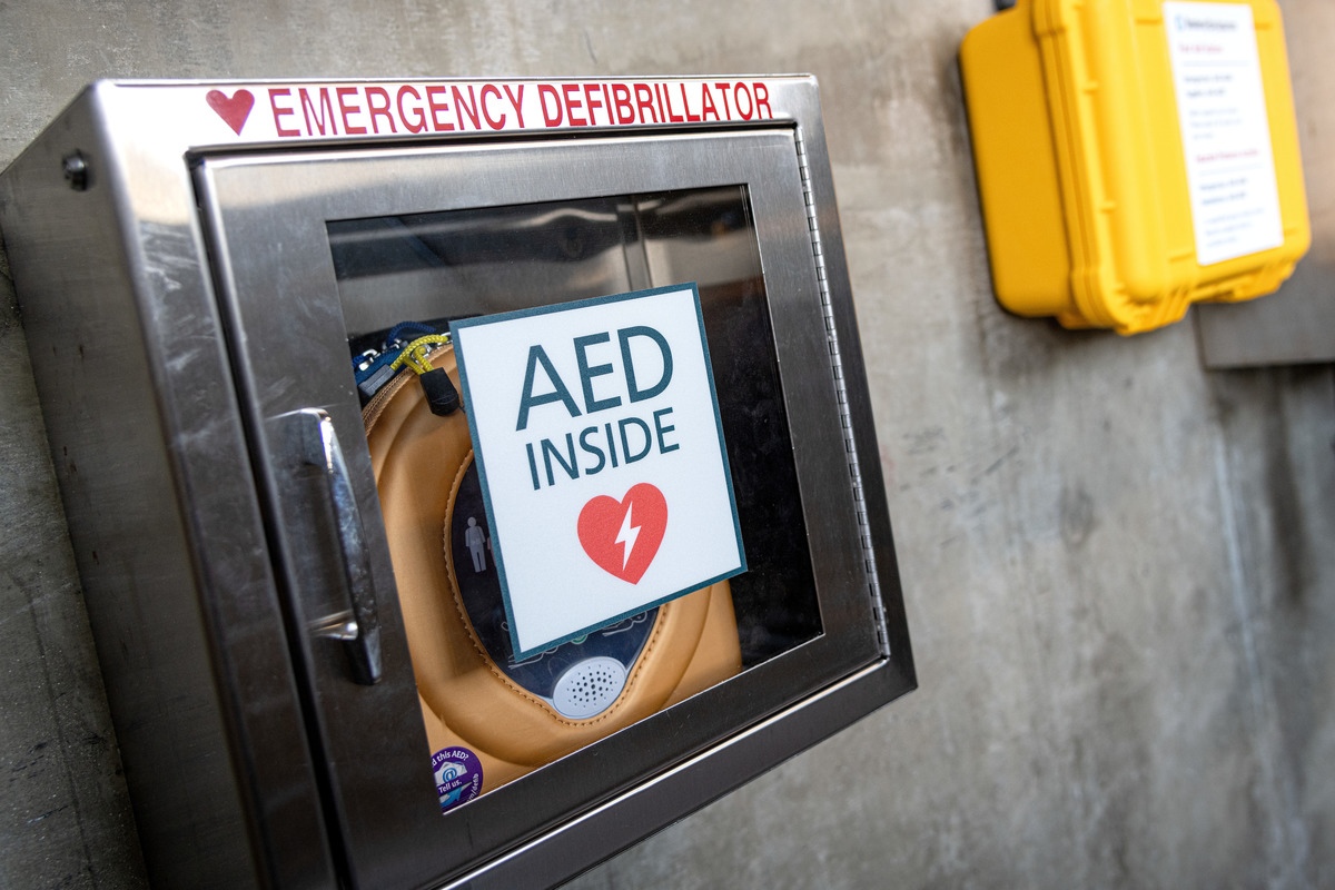 A closeup of an automated external defibrillator in its metal cabinet behind the scenes at the Aquarium