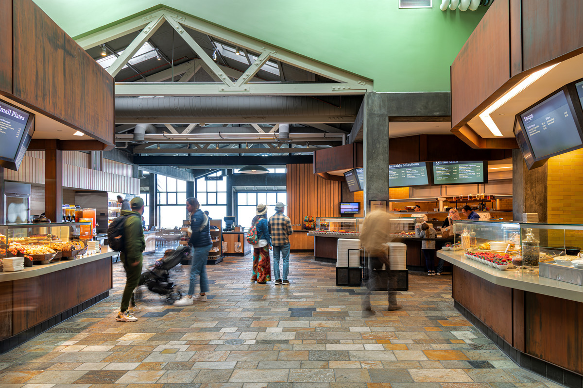 A number of guests look at all of the food options available in the cafe