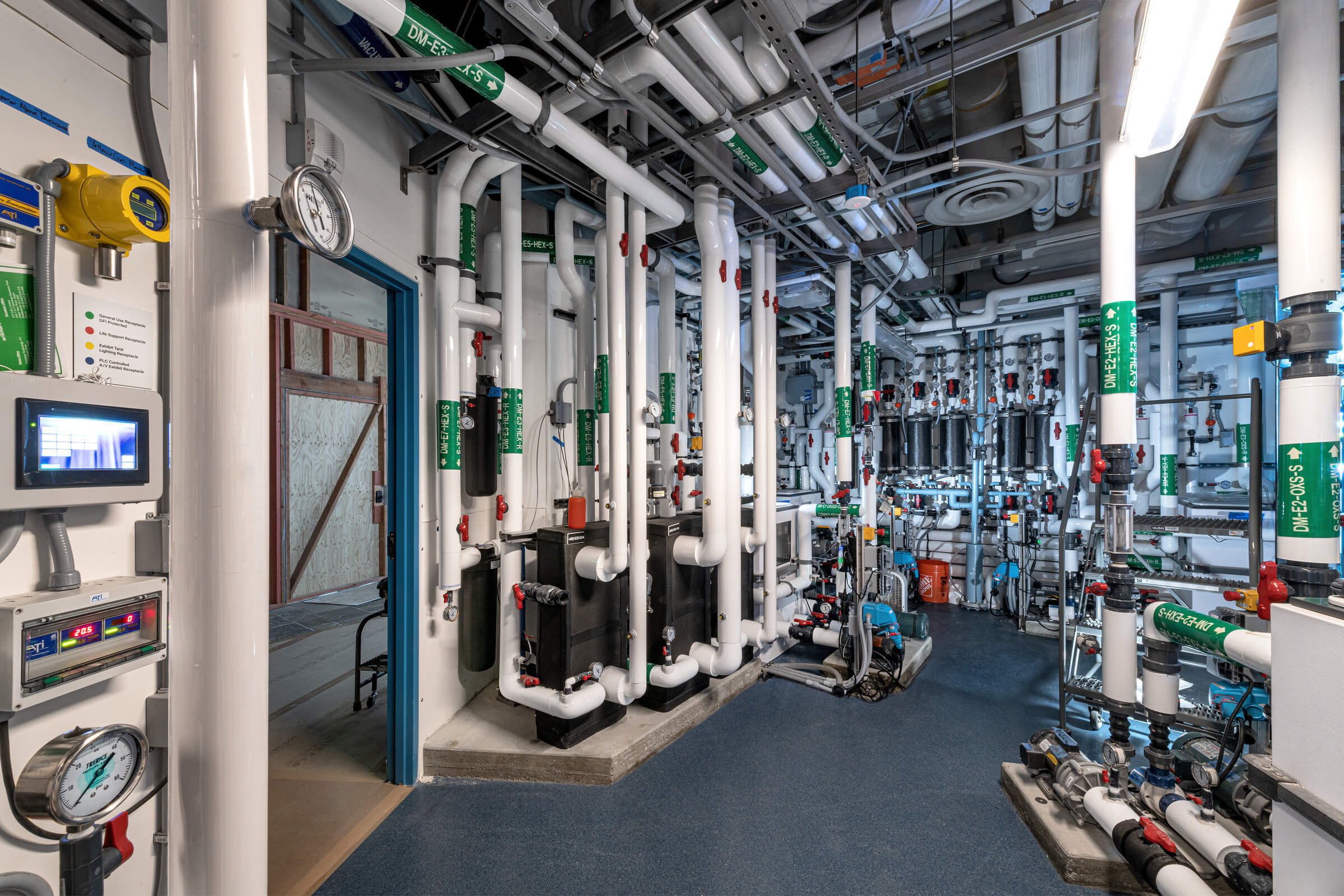 Behind the scenes of Into the Deep service area showing the pipes and plumbing