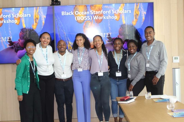 Group of Black Ocean Stanford Scholars (BOSS) Workshop participants posing together in front of program signage