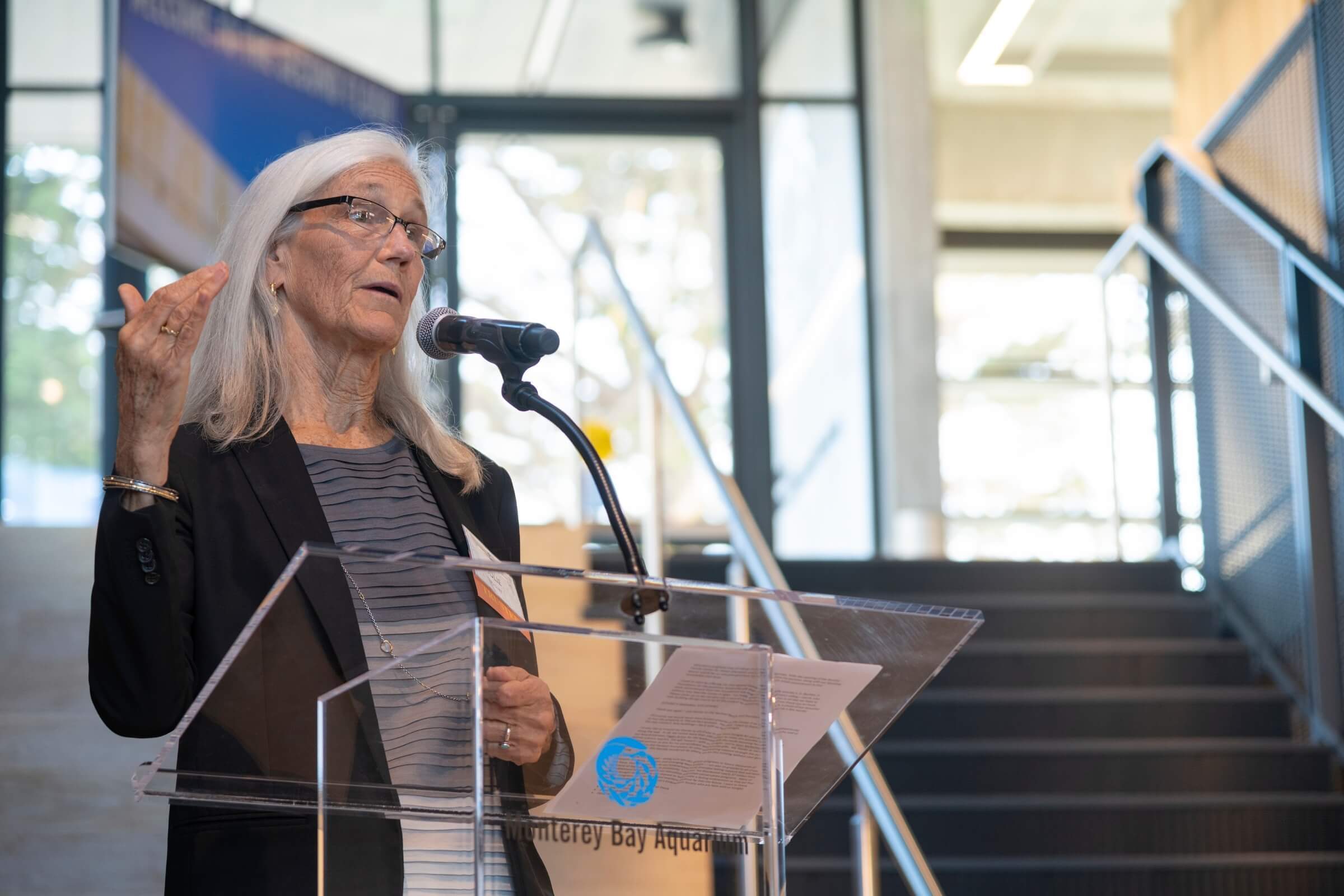 Julie Packard speaking at a podium at the Bechtel Family Education Center