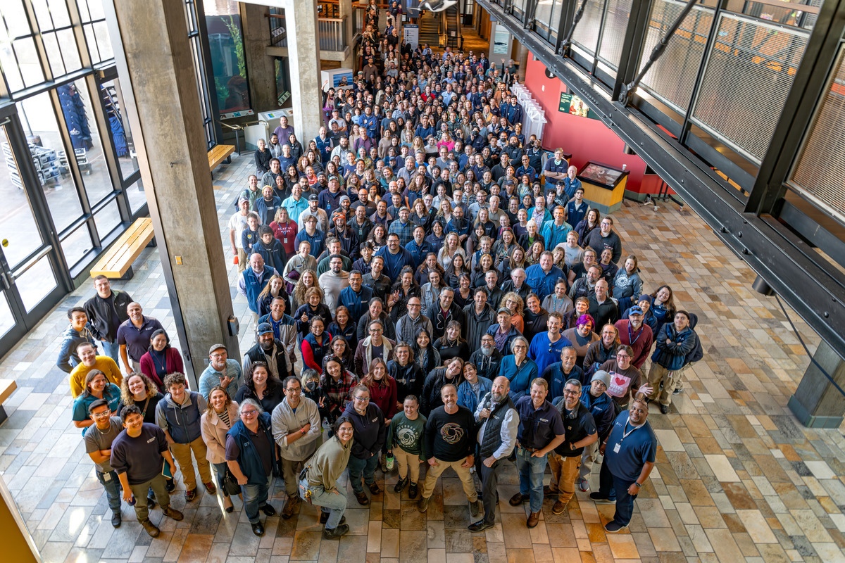 An arial view of most of the Aquarium staff standing in the Aquarium entrance