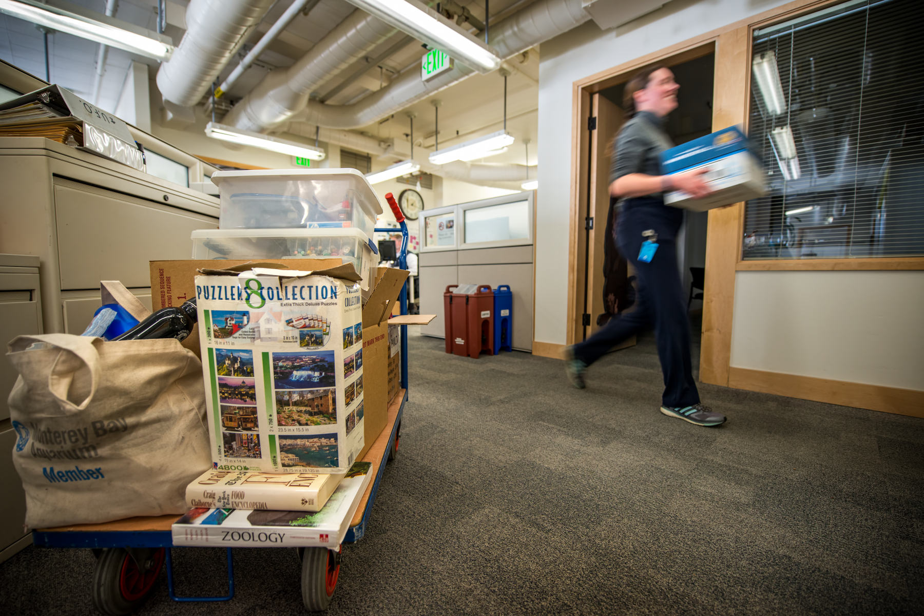 Hallway lined with stacked archive boxes and rolled blueprints