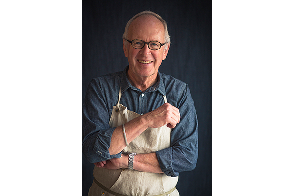 Photo of John Ash wearing an apron