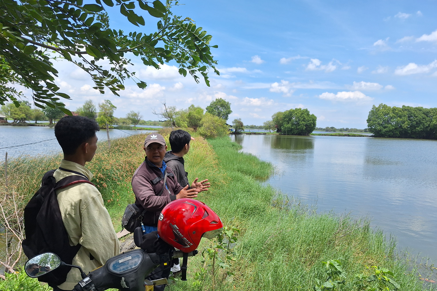 Monterey Bay Aquarium partners and farmers talking at a Vietnam mangrove shrimp farm