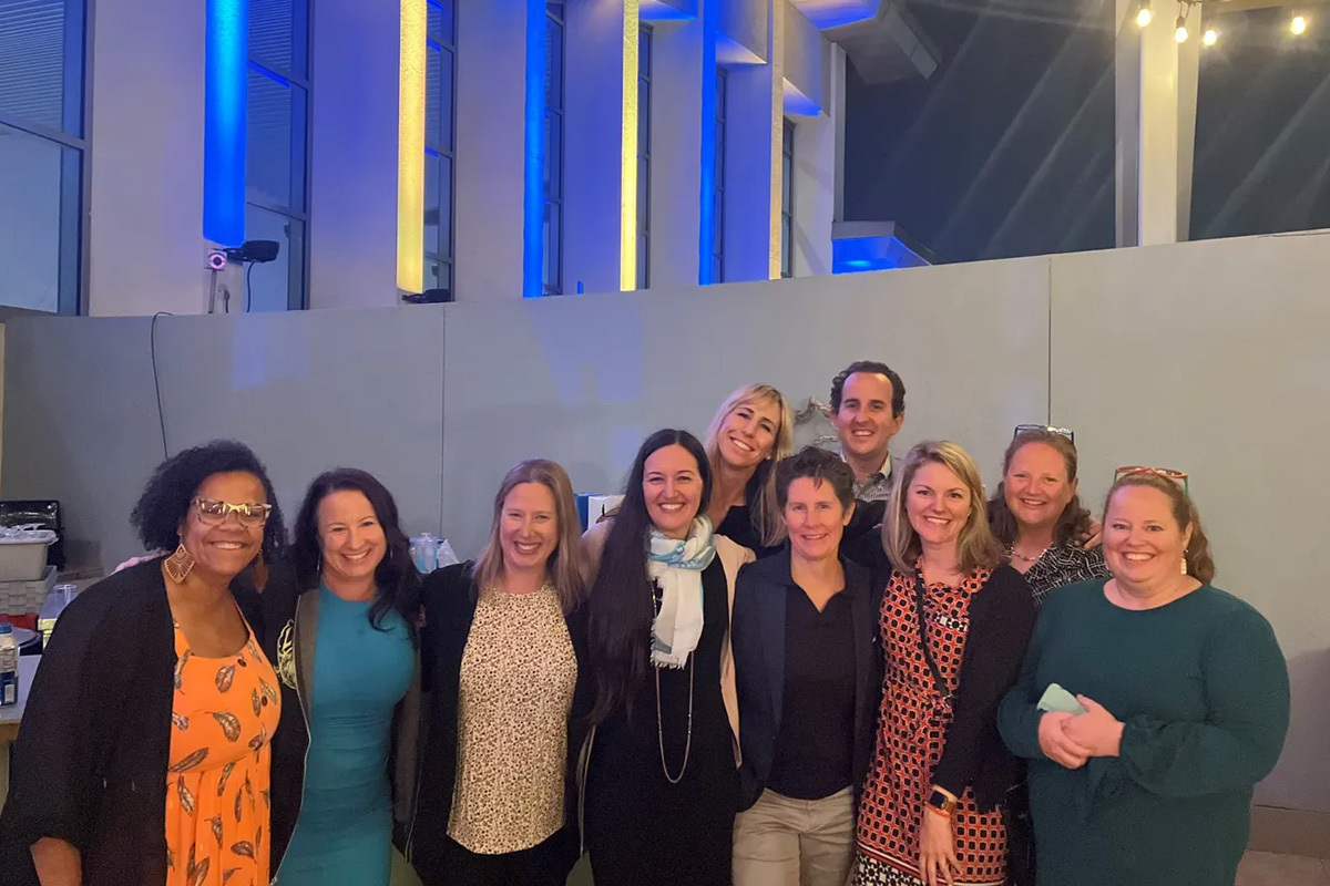 A group of colleagues from the Aquarium Conservation Partnership standing together while visiting the Aquarium of the Pacific