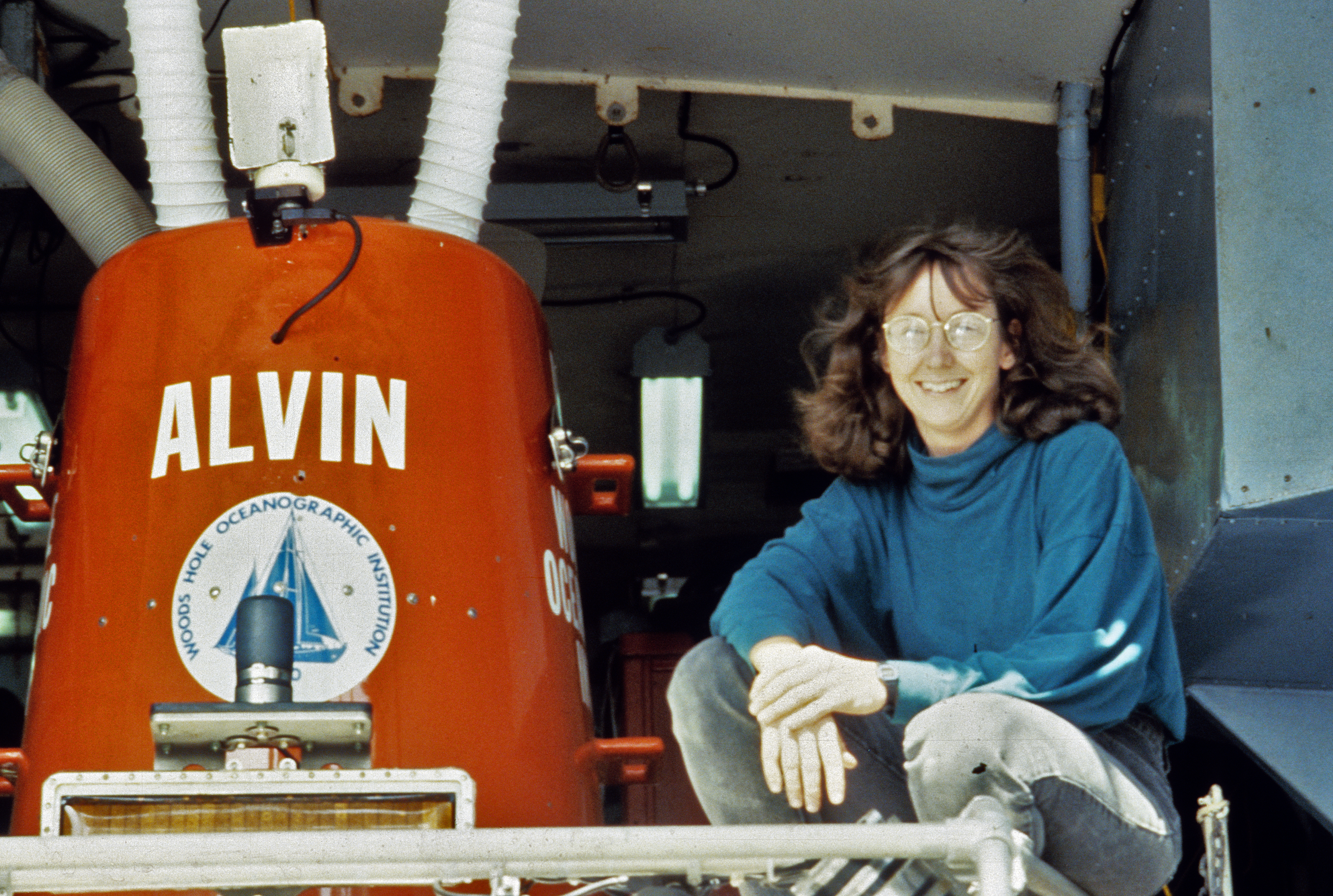 Dr. Cindy Lee Van Dover, kneeling next to Alvin
