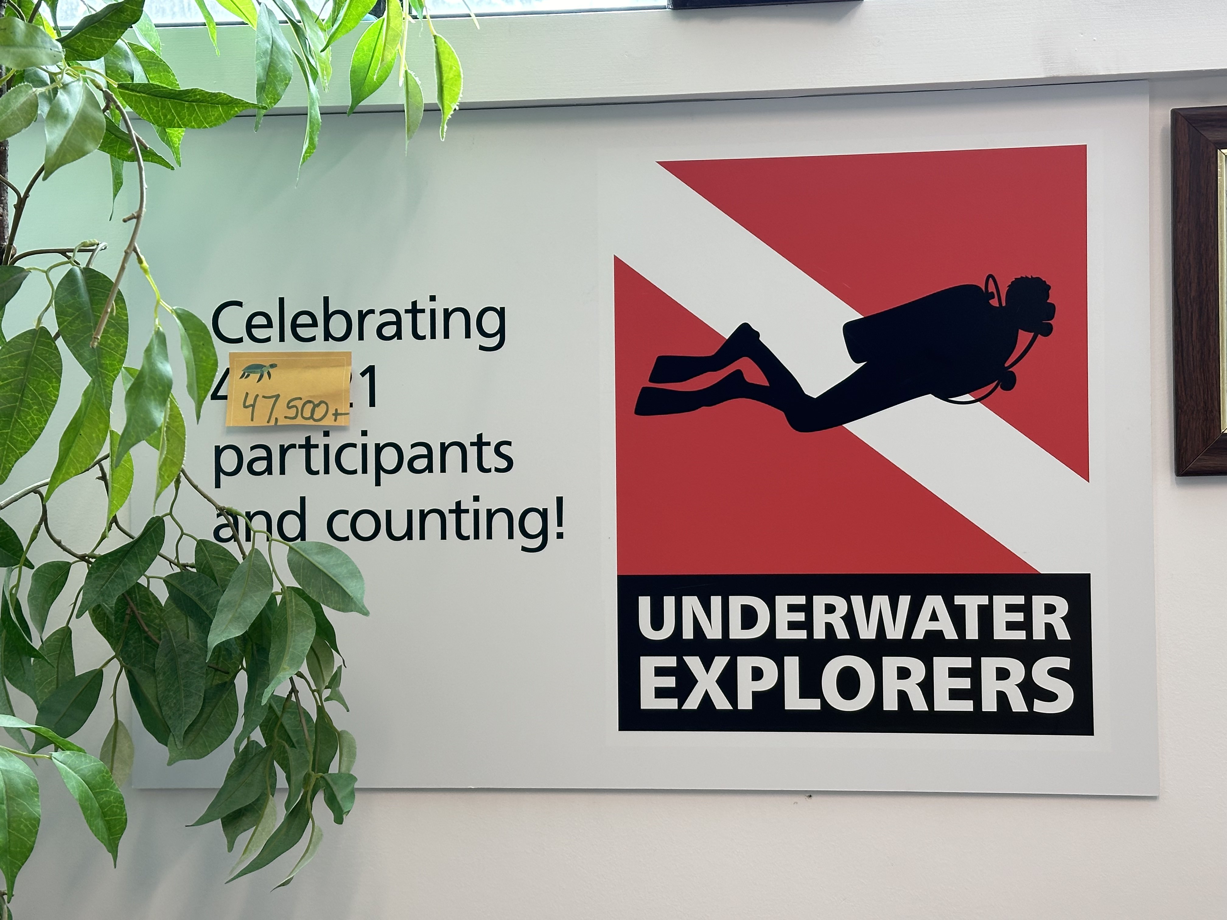 Underwater Explorers poster board counting the number of participants who have gone through the program.